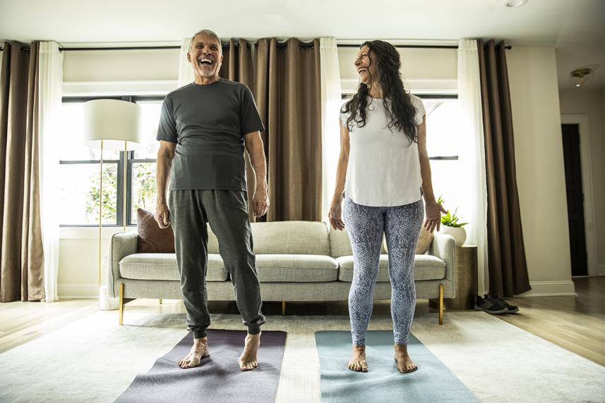 Couple doing yoga at home