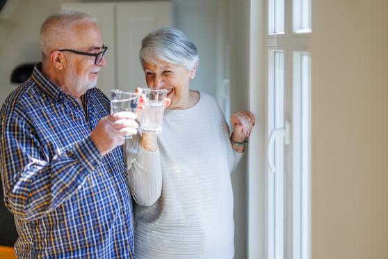 Happy older couple drinking water